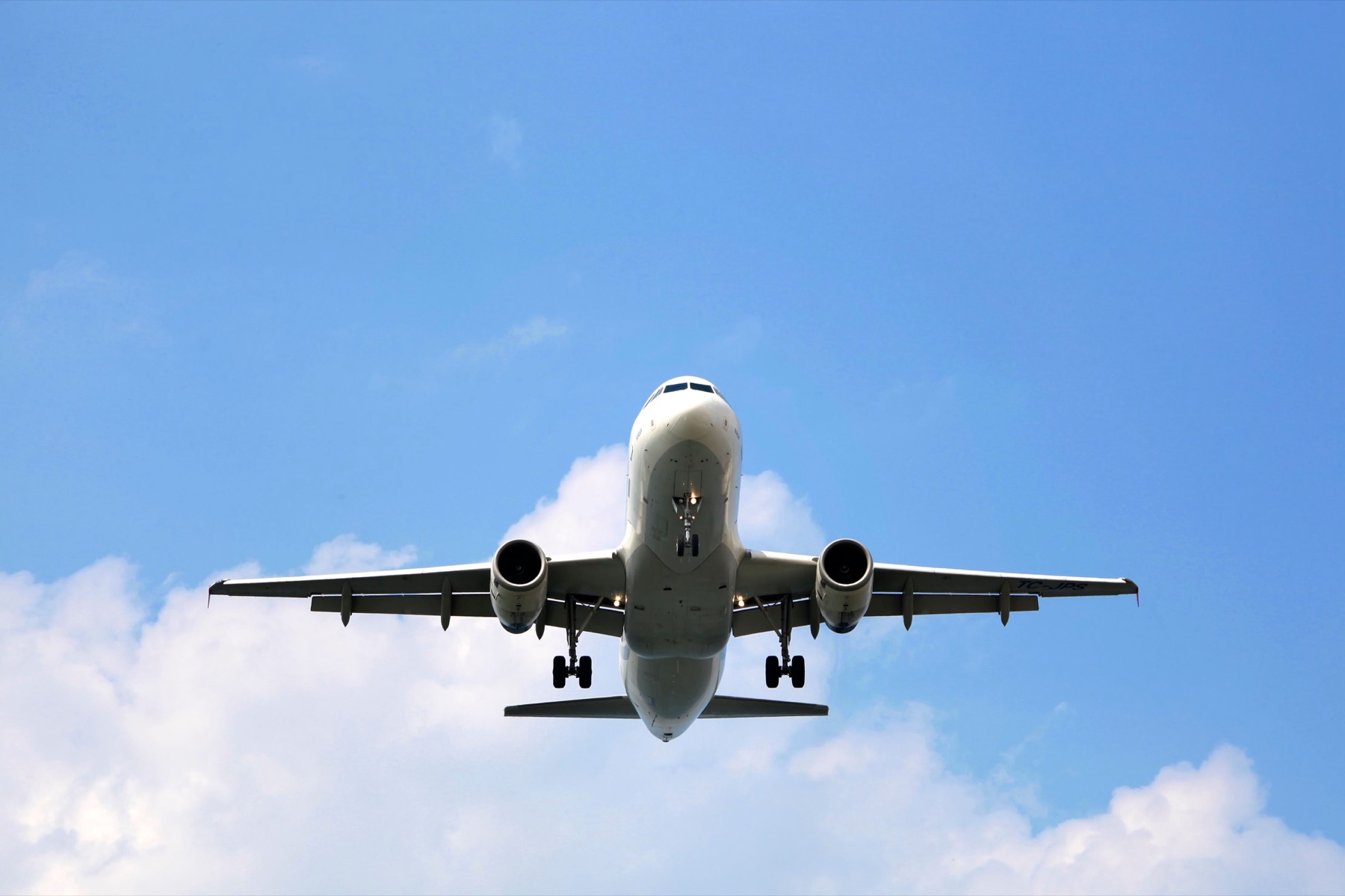 Airliner on final approach against a blue sky